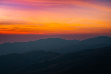 Wall Mural - panorama aerial view sunset , sunrise over dark mountain with fog over the ground.the early evening 
