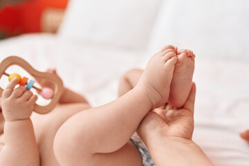 Sticker - Adorable hispanic toddler lying on bed having feet massage at bedroom