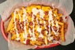 © miss - French fries with cheese and bacon in a basket