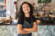 © Krakenimages.com - Young chinese woman waitress smiling confident standing with arms crossed gesture at restaurant