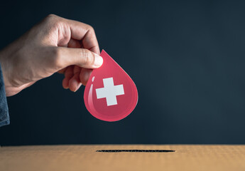 Wall Mural - hands drop blood paper cut to donation box, blood transfusion, world blood donor day, red cross to give blood.world hemophilia day concept