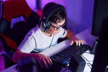 Sticker - Adorable hispanic boy streamer playing video game using computer at gaming room