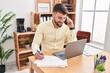 © Krakenimages.com - Young hispanic man business worker talking on the smartphone working at office