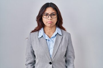 Poster - Hispanic young business woman wearing glasses skeptic and nervous, frowning upset because of problem. negative person.