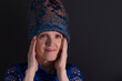 Nice low key portrait of mature Ukrainian  woman in in blue oriental clothes