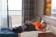 Lazy worker man lay down to sleep on the bed during working hours.