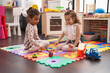 © Krakenimages.com - Two kids playing xylophone sitting on floor at kindergarten