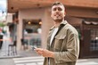 © Krakenimages.com - Young hispanic man using smartphone at street