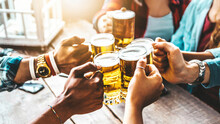 Happy Friends Cheering Beer Glasses At Brewery Pub Restaurant - Group Of Young People Enjoying Happy Hour Celebrating Party Outdoors - Beverage Life Style Concept With Guys And Girls Hanging Out