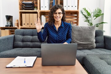 Sticker - Young brunette woman working at psychology clinic doing online appointment looking positive and happy standing and smiling with a confident smile showing teeth