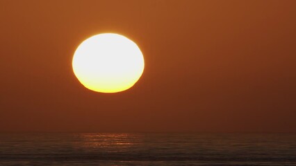 Wall Mural - beautiful evening sunset with big sun in the atlantic ocean at portugal coast.