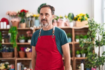 Sticker - Middle age man florist standing serious expression at florist