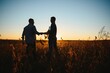 © Serhii - Two farmers shaking hands in soybean field.