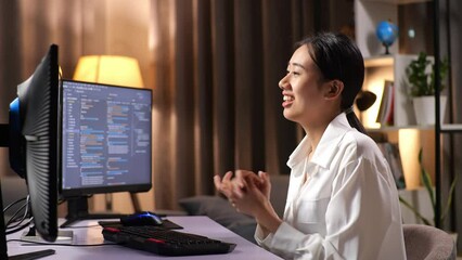 Asian Woman Programmer Waving Hand Having A Meeting On Desktop Computer While Creating Software Engineer Developing App, Program, Video Game At Home. Terminal With Coding Language 
