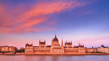 City Landscape At Sunset - View Of The Hungarian Parliament Building In The Historical Center Of Budapest On The Bank Of The Danube River, In Hungary