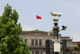 Fototapeta  - Chinese Flag on top of government building and security tiry camera on the foreground