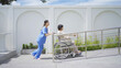 Old elderly disabled Asian patient or pensioner and a nurse using wheelchair in nursing home in hospital. Senior people lifestyle recreation. Health care therapy in garden park. Handicapped ramp