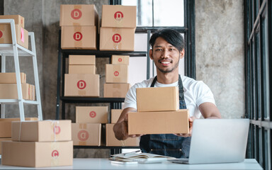 Handsome business sme owners in apron with delivery box package stock warehouse preparing after received online order from customer in social media in laptop, he is influencer.