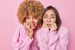 © wayhome.studio  - Nervous worried diverse women bite finger nails stare embarrassed at camera feel frightened watch horror movie wear casual clothes isolated over pink background. People and reactions concept