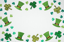St Patricks Day Shamrock And Green Leprechaun Hat Frame. Top Down View Over A White Background With Copy Space.