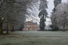 A View On A Stately Home Through Trees On A Frosty Winter Day. Frosty Park And Grounds. 