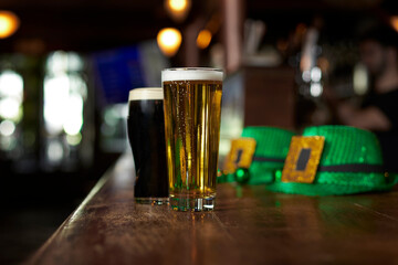 Two beers, hats and costume for St. Patrick's Day at the bar of an Irish pub