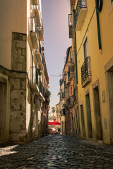 Beautiful old stone street in Lisbon Portugal at sunset in Europe