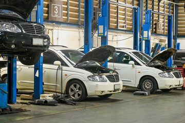 Service center in process of car maintenance, auto repair service station.