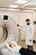 © Rabizo Anatolii - CT scan of abdomen of woman in medical clinic. Girl patient is doing CT computed tomography x-ray scan of chest for examination of abdomen in a CT scanning room.