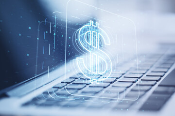 Poster - Close up of laptop computer on desktop with glowing dollar sign hologram on blurry background. Concept for investment and passive income, currency growth. Double exposure.
