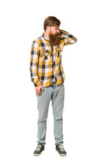 Young adult redhead man with a long beard standing full body isolated touching back of head, thinking and making a choice.