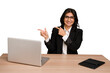 Young indian woman in a table with a laptop and tablet isolated excited pointing with forefingers away.