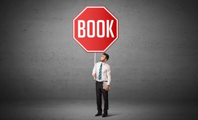 Young business person holding road sign