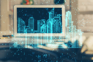 Poster - Desktop computer background in office and big town buildings hologram drawing. Double exposure. Smart city concept.