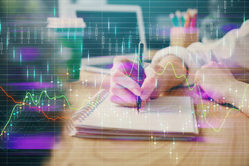Poster - Forex chart displayed on woman's hand taking notes background. Concept of research. Double exposure