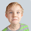 © azurita - Portrait of a smiling little boy on a grey background