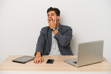 Young caucasian business entrepreneur man working with laptop, mobile phone and tablet