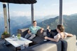 © Cavan Images - Young couple drinking wines on terrace, Zillertal, Tyrol, Austria