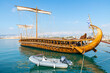 © Kirk Fisher - A replica of an ancient Greek Trireme battleship floats in the sea at the Flisvos Marina at Palaio Faliro, near Athens and Piraeus, Greece.
