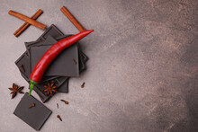 Delicious Chocolate, Fresh Red Chili Pepper And Spices On Grey Textured Table, Flat Lay. Space For Text