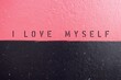Pink Black two tones wall with text inscription I LOVE MYSELF - concept of practice self-Love more than pleasing someone else - ones deserve to be loved not only by those around , boosting self-esteem