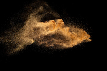 Wall Mural - dry river sand explosion. brown colored sand splash against black background.