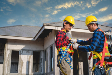 Portrait of male construction engineer and two construction workers Wearing safety clothes and safety equipment on the construction site for safety at work. teamwork concept