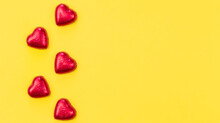 Chocolate Sweets In The Form Of Hearts On A Yellow Background, Flat Lay.