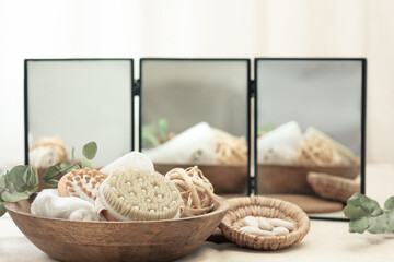 Poster - Spa composition with body care products on a blurred background with a mirror.