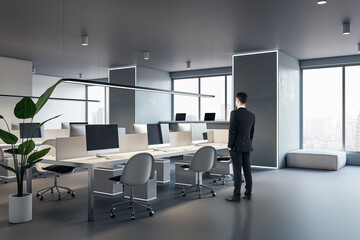 Aufkleber - thoughtful european businessman standing in modern concrete coworking office interior with window an