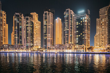Wall Mural - Night view of high-rise buildings of residential district in Dubai Marina. Dubai Marina Towers. Dubai Marina Skyline Background. Holidays In United Arab Emirates. Vacation In UAE. Night view of high