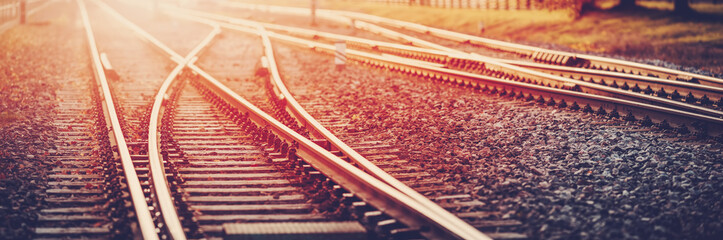 Wall Mural - panoramic view of the crossing railway in sunset in summer.