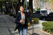 © PR Image Factory - worried asian chinese young female entrepreneur in hurry on street with a travel bag for not be late for an important business event