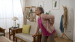 © PRPicturesProduction - asian senior lady is feeling pain for she sprained her lower back while she is walking into the living room at home and supporting herself with sofa armrest